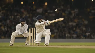 Cricket batter crouching to improvise a ramp shot with the wicketkeeper behind the stumps